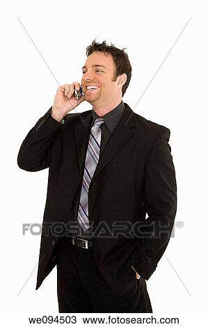 Caucasian businessman standing and talking on the cell phone and smiling View Large Photo Image Stock Image - Caucasian businessman standing and talking on the cell phone and smiling. Fotosearch
