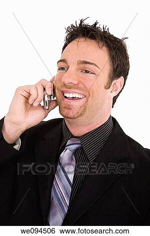 Caucasian businessman standing and talking on the cell phone and smiling View Large Photo Image Stock Photograph - Caucasian businessman standing and talking on the cell phone and smiling. Fotosearch