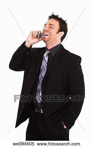 Caucasian businessman standing and talking on the cell phone and smiling View Large Photo Image Stock Photography - Caucasian businessman standing and talking on the cell phone and smiling. Fotosearch
