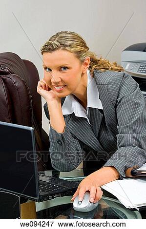Caucasian businesswoman in her early 30s setting at a desk going over a day planner View Large Photo Image Stock Photo - Caucasian businesswoman in her early 30s setting at a desk going over a day planner. Fotosearch