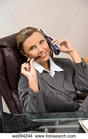Caucasian businesswoman / secretary in her early 30s talking on a headset View Large Photo Image Picture - Caucasian businesswoman / secretary in her early 30s talking on a headset. Fotosearch