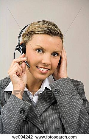 Caucasian businesswoman / secretary in her early 30s talking on a headset View Large Photo Image Stock Image - Caucasian businesswoman / secretary in her early 30s talking on a headset. Fotosearch