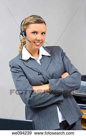 Caucasian businesswoman / secretary in her early 30s talking on a headset View Large Photo Image Stock Photo - Caucasian businesswoman / secretary in her early 30s talking on a headset. Fotosearch