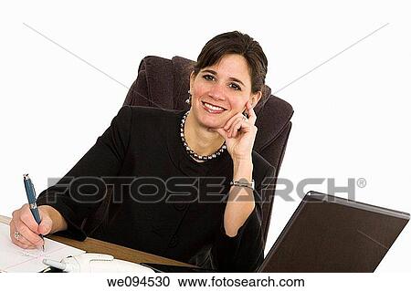 Caucasian businesswoman setting a desk and smiling View Large Photo Image Stock Image - Caucasian businesswoman setting a desk and smiling. Fotosearch