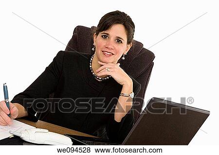 Caucasian businesswoman setting a desk and smiling View Large Photo Image Stock Photo - Caucasian businesswoman setting a desk and smiling. Fotosearch