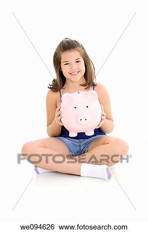 Caucasian child holding a piggy bank on her lap View Large Photo Image Stock Photograph - Caucasian child holding a piggy bank on her lap. Fotosearch