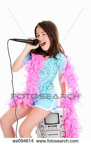 Caucasian children singing karaoke on a white background View Large Photo Image Picture - Caucasian children singing karaoke on a white background. Fotosearch