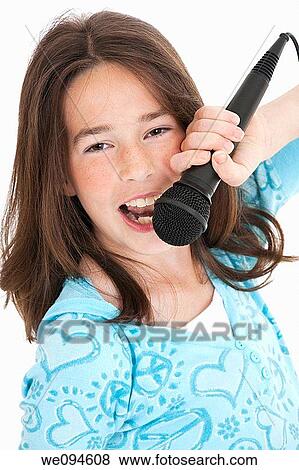 Caucasian children singing karaoke on a white background View Large Photo Image Stock Photo - Caucasian children singing karaoke on a white background. Fotosearch