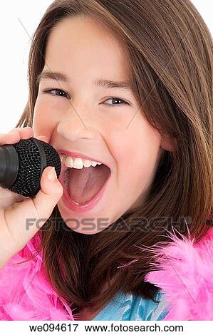 Caucasian children singing karaoke on a white background View Large Photo Image Stock Photo - Caucasian children singing karaoke on a white background. Fotosearch