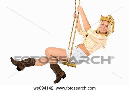 Caucasian cowgirl in wooden swing on white background View Large Photo Image Stock Image - Caucasian cowgirl in wooden swing on white background. Fotosearch