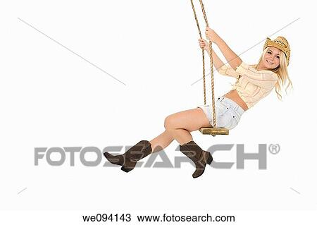 Caucasian cowgirl in wooden swing on white background View Large Photo Image Stock Image - Caucasian cowgirl in wooden swing on white background. Fotosearch