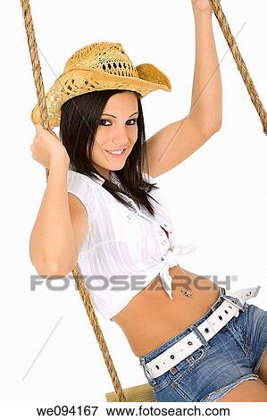 Caucasian cowgirl in wooden swing on white background View Large Photo Image Stock Photo - Caucasian cowgirl in wooden swing on white background. Fotosearch