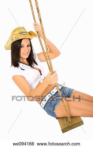 Caucasian cowgirl in wooden swing on white background View Large Photo Image Stock Photograph - Caucasian cowgirl in wooden swing on white background. Fotosearch