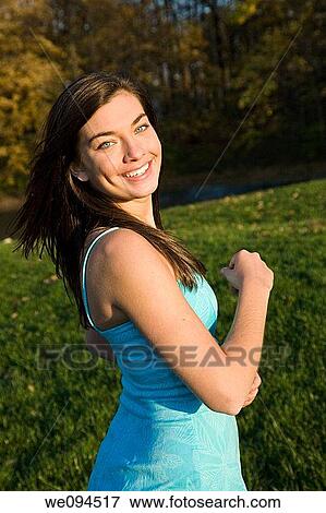 Caucasian female teenager horsing around in a park View Large Photo Image Stock Photo - Caucasian female teenager horsing around in a park. Fotosearch