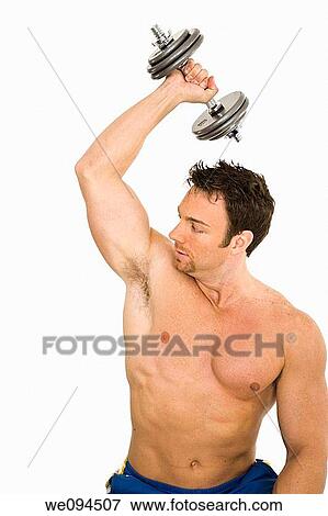 Caucasian man working out with dumbbells on a white background View Large Photo Image Stock Photo - Caucasian man working out with dumbbells on a white background. Fotosearch