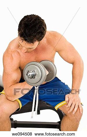 Caucasian man working out with dumbbells on a white background View Large Photo Image Stock Photo - Caucasian man working out with dumbbells on a white background. Fotosearch