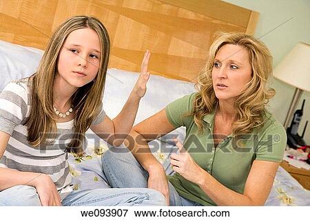 Caucasian mother and preteen daughter arguing while setting on bed an master bedroom View Large Photo Image Stock Photo - Caucasian mother and preteen daughter arguing while setting on bed an master bedroom. Fotosearch