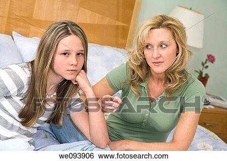 Caucasian mother and preteen daughter arguing while setting on bed an master bedroom View Large Photo Image Stock Photograph - Caucasian mother and preteen daughter arguing while setting on bed an master bedroom. Fotosearch
