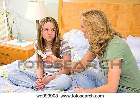 Stock Photo - Caucasian mother upset after finding cigarettes in her preteen daughters room. Fotosearch