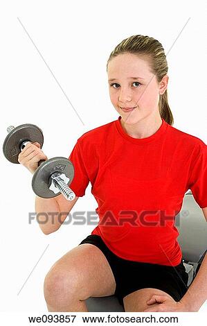 Stock Photo - Caucasian preteen female lifting weights using a dumbbell on a white background. Fotosearch