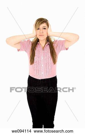Picture - Caucasian teenager displaying some attitude with the Hear No Evil hands over ears. Fotosearch