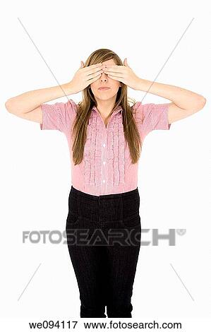 Stock Photo - Caucasian teenager displaying some attitude with the See No Evil hands over eyes. Fotosearch