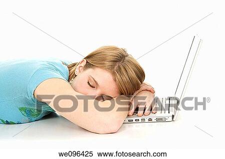 Caucasian teenager sleeping while working on a laptop computer View Large Photo Image Stock Photography - Caucasian teenager sleeping while working on a laptop computer. Fotosearch