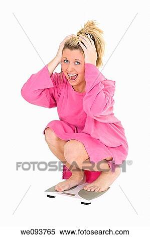 Caucasian teenager standing on a scale weighting herself and very upset View Large Photo Image Stock Photography - Caucasian teenager standing on a scale weighting herself and very upset. Fotosearch
