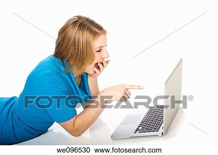 Caucasian teenager woking on laptop computer View Large Photo Image Stock Image - Caucasian teenager woking on laptop computer. Fotosearch