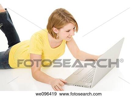 Stock Photo - Caucasian teenager woking on laptop computer. Fotosearch