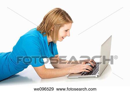 Caucasian teenager woking on laptop computer View Large Photo Image Stock Photo - Caucasian teenager woking on laptop computer. Fotosearch