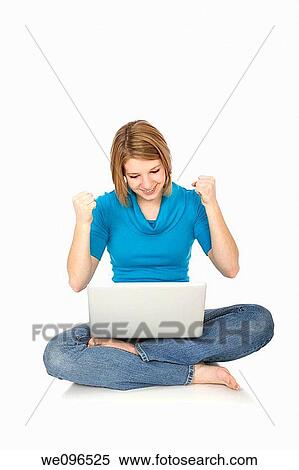 Stock Photography - Caucasian teenager woking on laptop computer. Fotosearch