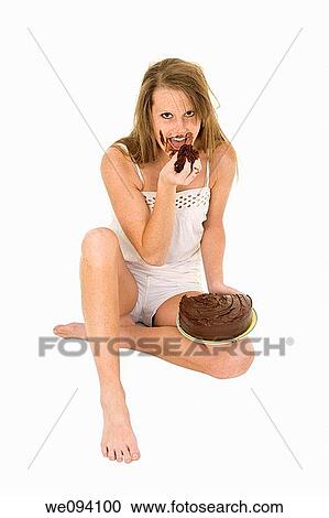 Caucasian woman eating a chocolate cake on white background View Large Photo Image Stock Image - Caucasian woman eating a chocolate cake on white background. Fotosearch