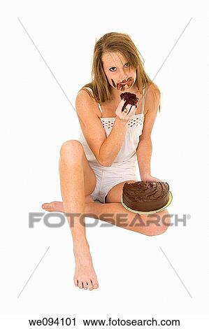 Caucasian woman eating a chocolate cake on white background View Large Photo Image Stock Image - Caucasian woman eating a chocolate cake on white background. Fotosearch