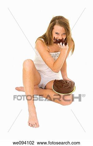 Caucasian woman eating a chocolate cake on white background View Large Photo Image Stock Image - Caucasian woman eating a chocolate cake on white background. Fotosearch