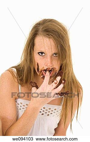 Caucasian woman eating a chocolate cake on white background View Large Photo Image Stock Image - Caucasian woman eating a chocolate cake on white background. Fotosearch