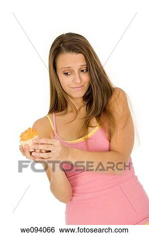 Caucasian woman eating a chocolate cupcake on a white background View Large Photo Image Stock Photograph - Caucasian woman eating a chocolate cupcake on a white background. Fotosearch