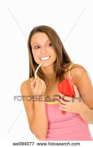 Caucasian woman eating junk food on a white background View Large Photo Image Stock Photo - Caucasian woman eating junk food on a white background. Fotosearch