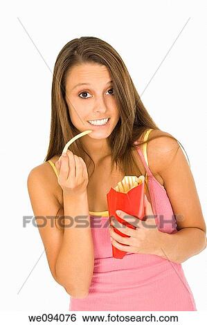 Caucasian woman eating junk food on a white background View Large Photo Image Stock Photograph - Caucasian woman eating junk food on a white background. Fotosearch