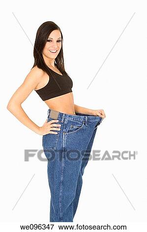Caucasian woman hold old jeans to show weight loss View Large Photo Image Stock Photo - Caucasian woman hold old jeans to show weight loss. Fotosearch