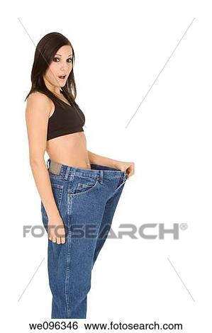 Caucasian woman hold old jeans to show weight loss View Large Photo Image Stock Photograph - Caucasian woman hold old jeans to show weight loss. Fotosearch