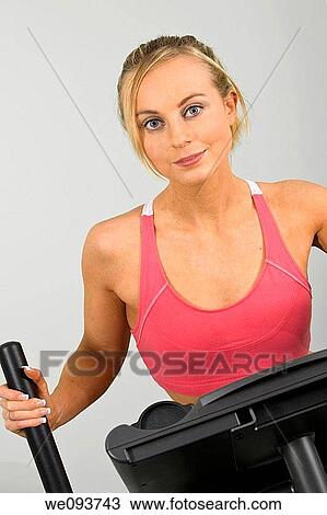 Caucasian woman in early 20s exercising on a cardiovascular machine View Large Photo Image Stock Image - Caucasian woman in early 20s exercising on a cardiovascular machine. Fotosearch