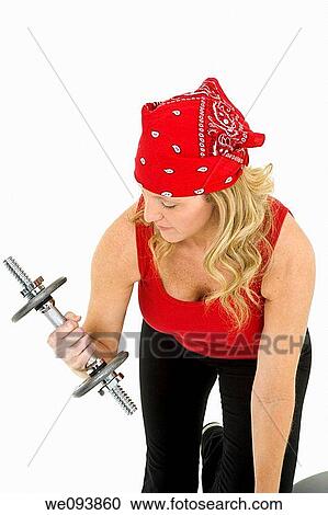 Caucasian woman in early 40s lifting weights using a dumbbell on a white background View Large Photo Image Stock Image - Caucasian woman in early 40s lifting weights using a dumbbell on a white background. Fotosearch