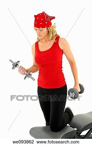 Caucasian woman in early 40s lifting weights using a dumbbell on a white background View Large Photo Image Stock Image - Caucasian woman in early 40s lifting weights using a dumbbell on a white background. Fotosearch