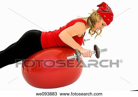 Caucasian woman in early 40s lifting weights using a excerise ball and dumbbell on a white background View Large Photo Image Stock Image - Caucasian woman in early 40s lifting weights using a excerise ball and dumbbell on a white background. Fotosearch