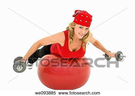 Caucasian woman in early 40s lifting weights using a excerise ball and dumbbell on a white background View Large Photo Image Stock Photography - Caucasian woman in early 40s lifting weights using a excerise ball and dumbbell on a white background. Fotosearch