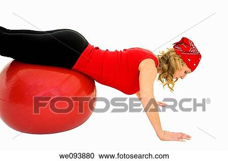 Caucasian woman in early 40s using a excerise ball on a white background View Large Photo Image Stock Image - Caucasian woman in early 40s using a excerise ball on a white background. Fotosearch