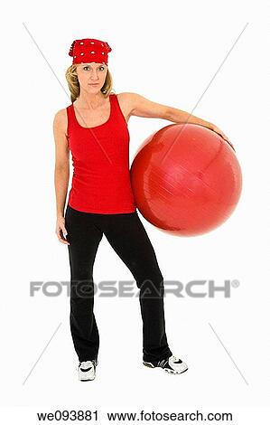Caucasian woman in early 40s using a excerise ball on a white background View Large Photo Image Stock Image - Caucasian woman in early 40s using a excerise ball on a white background. Fotosearch