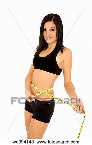 Caucasian woman measuring her waist on a white background View Large Photo Image Stock Photo - Caucasian woman measuring her waist on a white background. Fotosearch