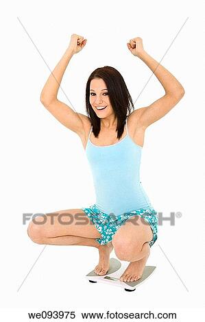 Caucasian woman standing on a scale weighting herself and very upset View Large Photo Image Stock Photography - Caucasian woman standing on a scale weighting herself and very upset. Fotosearch